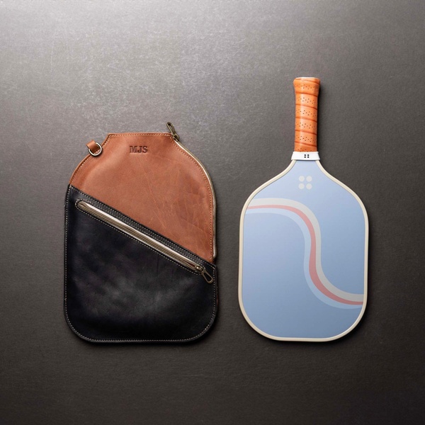 pickleball paddle, paddle bag, sports equipment, racket bag, pickleball gear, product demo, minimalist, flat lay, calm, trustworthy, neutral, brown, blue